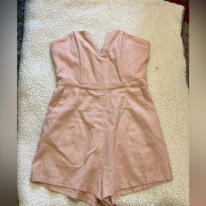 This is a baby pink romper from Showpo. It has pockets and a zip in the back!